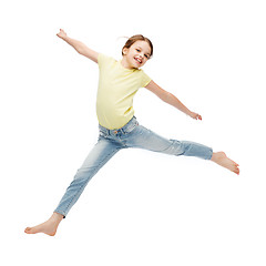 Image showing smiling little girl jumping