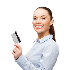 Image showing smiling businesswoman showing credit card