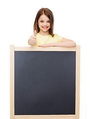 Image showing happy little girl with blank blackboard