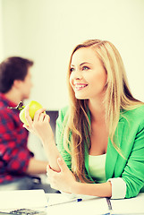 Image showing student girl with green apple in college