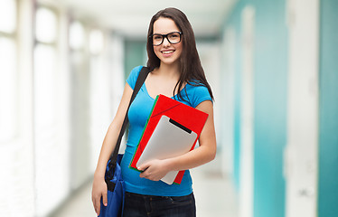 Image showing smiling student with bag, folders and tablet pc