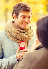 Image showing man proposing to a woman in the autumn park