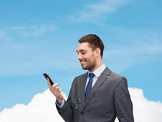 Image showing young smiling businessman with smartphone