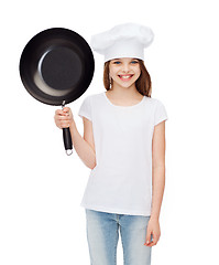 Image showing smiling girl in cook hat with frying pan