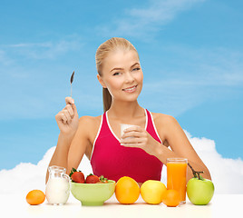 Image showing young woman eating healthy breakfast