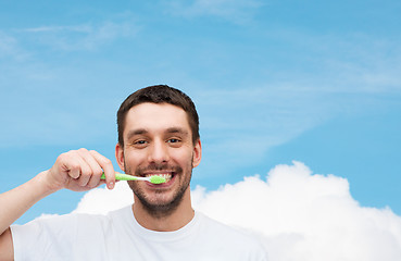 Image showing smiling young man with toothbrush