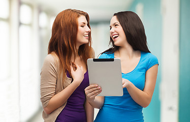 Image showing two smiling teenagers with tablet pc computer