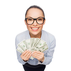 Image showing smiling businesswoman with dollar cash money