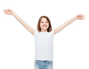 Image showing smiling teenage girl with raised hands