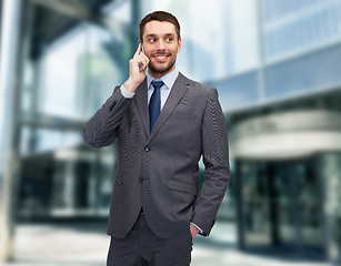 Image showing young smiling businessman with smartphone