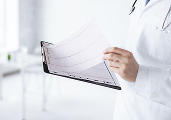 Image showing male doctor hands holding cardiogram