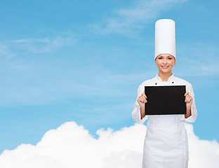 Image showing smiling female chef with black blank paper