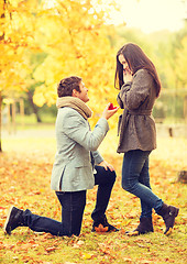 Image showing man proposing to a woman in the autumn park