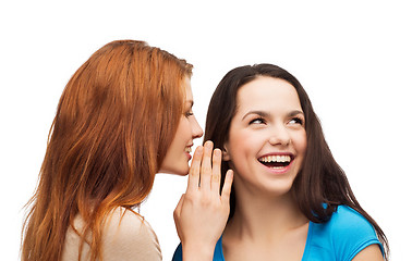 Image showing one girl telling another secret