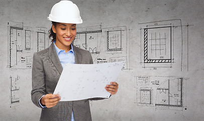 Image showing businesswoman in white helmet with blueprint