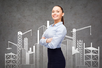 Image showing young smiling businesswoman with crossed arms