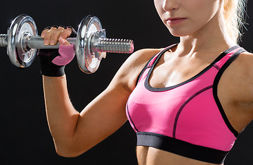 Image showing close up of sporty woman with heavy steel dumbbell