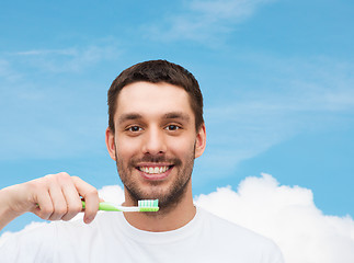 Image showing smiling young man with toothbrush