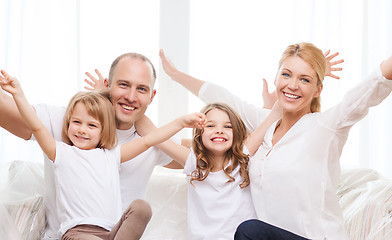 Image showing smiling parents and two little girls at new home