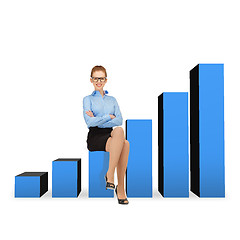 Image showing smiling businesswoman in glasses sitting on chart