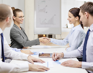 Image showing two businesswomen shaking hands in office