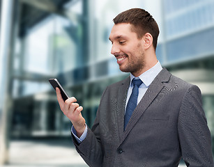 Image showing young smiling businessman with smartphone