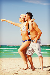 Image showing happy couple in sunglasses on the beach