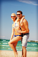 Image showing happy couple in sunglasses on the beach