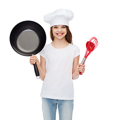 Image showing smiling girl in cook hat with ladle, whisk and pan