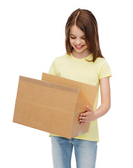 Image showing smiling little girl with many cardboard boxes