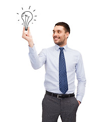 Image showing handsome businessman holding light bulb