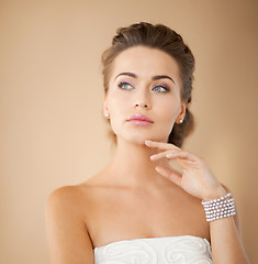 Image showing woman with pearl earrings and bracelet