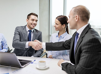 Image showing two businessman shaking hands in office