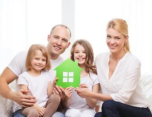 Image showing smiling parents and two little girls at new home