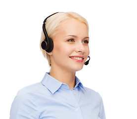 Image showing friendly female helpline operator with headphones