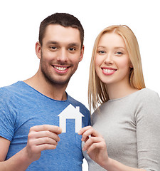 Image showing smiling couple holding white paper house