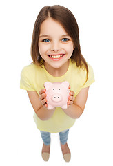 Image showing beautiful little girl with piggy bank