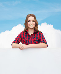 Image showing smiling young teenage girl with white blank board