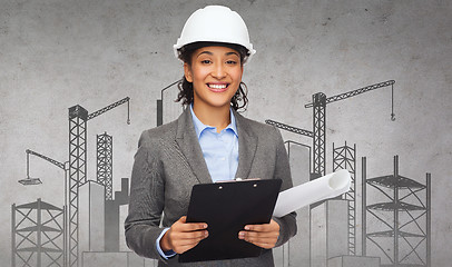 Image showing businesswoman in white helmet with clipboard