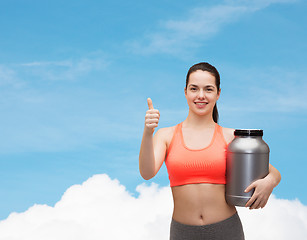 Image showing teenage girl with jar of protein showing thumbs up