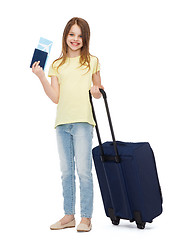 Image showing smiling girl with suitcase, ticket and passport