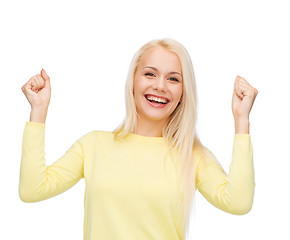 Image showing laughing young woman with hands up