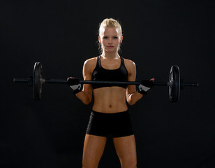 Image showing sporty woman exercising with barbell