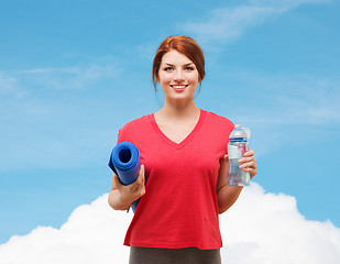 Image showing smiling girl with bottle of water after exercising