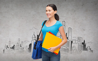 Image showing smiling female student with bag and folders