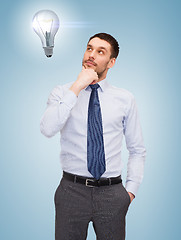 Image showing handsome businessman looking up