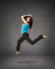 Image showing beautiful sporty woman jumping in sportswear