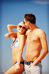 Image showing happy couple in sunglasses on the beach