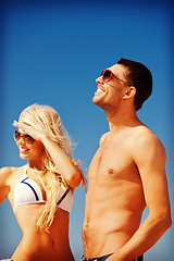 Image showing happy couple in sunglasses on the beach