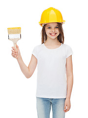 Image showing smiling little girl in helmet with paint brush